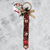 Festive Christmas Door Hanger with Bells 45 cm featuring red fabric, bells, and a decorative bow.