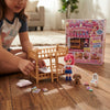 Child playing with Doll Bedroom Play Set featuring bunk beds, accessories, and dolls in a cozy room.