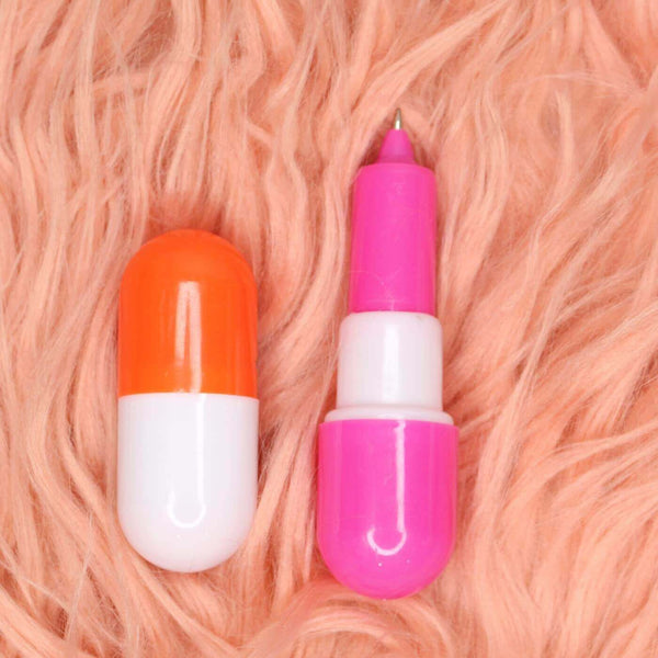 Capsule-Shaped Writing Pen displayed on fluffy pink background, showcasing playful capsule design and vibrant colors.