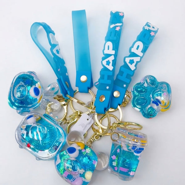 Blue Liquid Glitter Floating Charm Keychain featuring various glittery charms and blue straps.