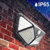 114 Solar Motion Sensor LED Wall Light mounted on a brick wall, demonstrating IP65 waterproof rating.