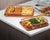 Copper Crispy Tray with crispy fried food and grilled vegetables on a countertop.