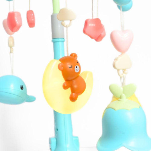 Close-up of adorable figures on a Rotating Musical Baby Crib Mobile with Projection, featuring a bear and colorful shapes.