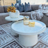 Modern White Round Coffee Table Set displayed in a stylish living room with decor and textured cushions.