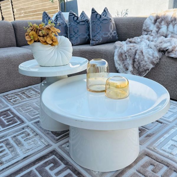 Modern White Round Coffee Table Set displayed in a stylish living room with decor and textured cushions.