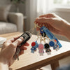 Hands holding keys with 3D Silicone Astronaut Keychain and colorful astronaut figures, showcasing fun space-themed accessories.