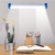 Portable Solar LED Emergency Light System illuminating a desk with plants, stationery, and a magnifying glass.