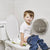 Toddler using the 2 in 1 Go Potty on a standard toilet, designed for stress-free potty training.