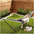 Portable Striped Hammock Swing Chair with a person relaxing outdoors in a garden setting.