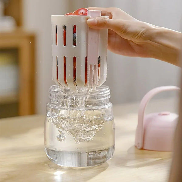Person using a 2-in-1 Fresh Food Salad Tumbler to rinse fruits in a jar of water.