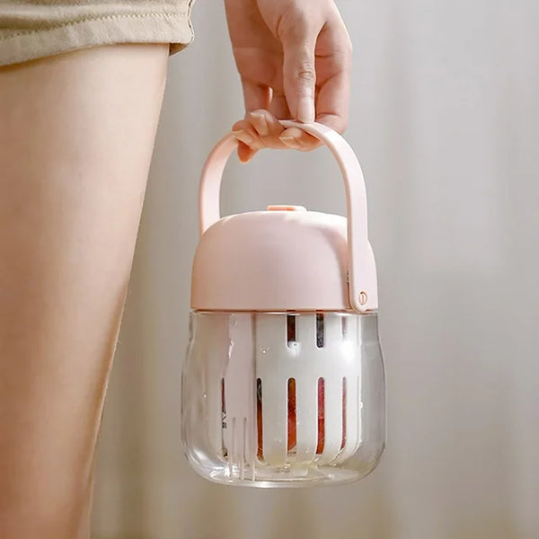 A person holding a 2-in-1 Fresh Food Salad Tumbler with a pink handle, showcasing its portable design for fresh meals.