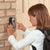 Child using Wall Mounted Aluminium Key Lock Box to access keys securely on a brick wall.