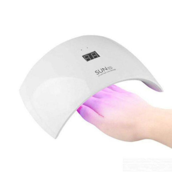 24 W Professional LED UV Nail Dryer curing gel polish with LED/UV technology in a small salon setup.