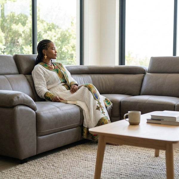 Modern L-Shape Sectional Lounge Suite with woman relaxing in stylish living room setting.