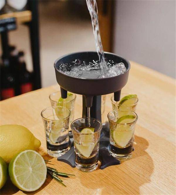 6 Shot Dispenser pouring shots into six glasses with lime slices, perfect for parties and events.