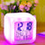 Color Change Digital Alarm Clock with LED display showing time and date, in vibrant colors on a bedside table.