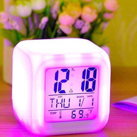 Color Change Digital Alarm Clock with LED display showing time and date, in vibrant colors on a bedside table.
