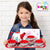 A child happily holds the Floral 15-Piece Kids Tin Tea Set with Carrying Case, featuring a teapot and cups.
