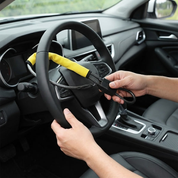 Car Steering Wheel Wire Rope Lock being installed on a steering wheel for anti-theft security.