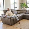 Modern L-Shape Sectional Lounge Suite featuring a woman relaxing with a book in a stylish living room.