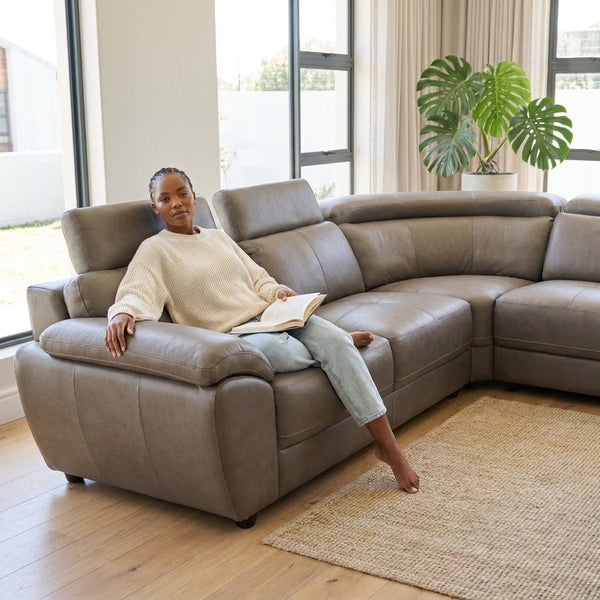 Modern L-Shape Sectional Lounge Suite featuring a woman relaxing with a book in a stylish living room.