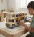 Child playing with Electric Gear Retro Double-Decker Bus Toy featuring an interactive gear mechanism.