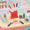 Kitchen Helper Happy Little Chef Pretend Play knife set with colorful toy knives and play food on a kitchen countertop.