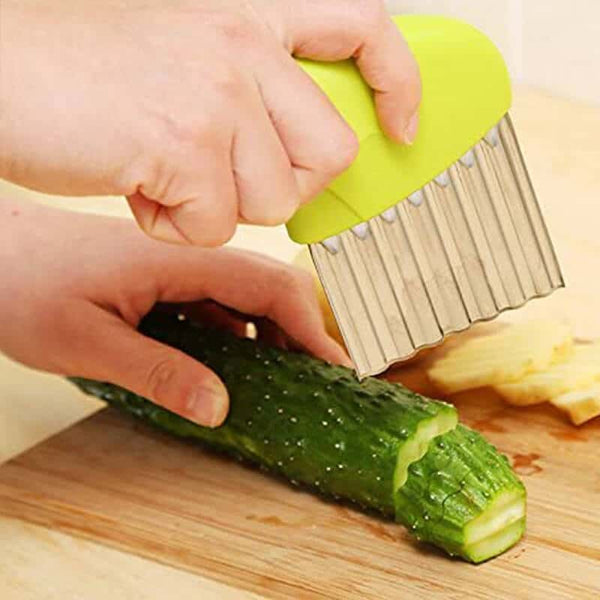 Hand using Crinkle Cutter Chopping Tool Slicer on a cucumber, creating crinkle-cut shapes for garnish.