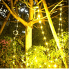 3 Modes Portable Camping String Lights hanging on a tree, illuminating outdoor foliage in a warm glow.