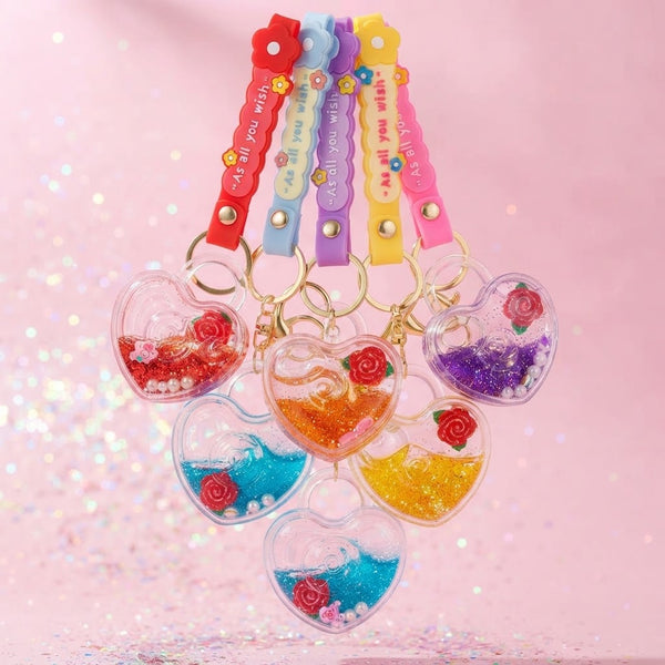 Heart-Shaped Liquid Glitter Keychain with colorful glitter and decorative elements in a charming display.