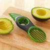 3 in 1 Avocado Slicer on a wooden cutting board with sliced avocado.