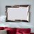 Ruby Wall Mirror with a modern, stylish frame enhancing room decor and reflecting light.
