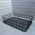 Metal Wire Grid Basket Organizer displayed against a white brick wall for stylish home organization.