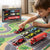 Child playing with 7-Piece Die-Cast Alloy Racing & Rescue Vehicle Gift Set on a colorful play mat.