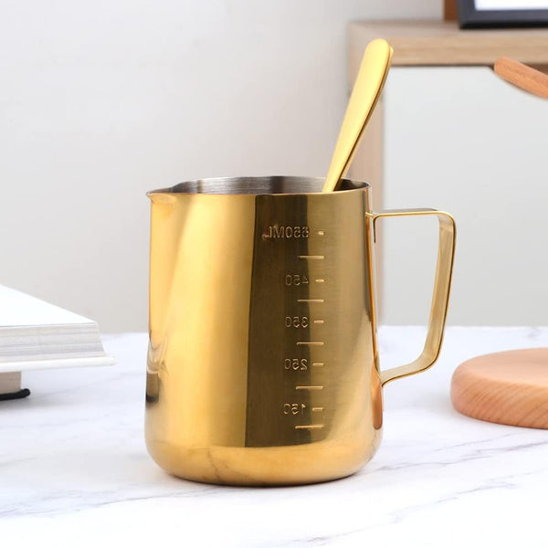 Gold Stainless Steel Milk Frothing Pitcher 350ML with handle and measurement markings on a tabletop.