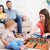 Family enjoying the 2 Player Tabletop Football Game together in a living room setting.