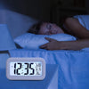 Smart Digital LCD Desk Clock with Temperature Display illuminating bedside in a dark room while a person peacefully sleeps.
