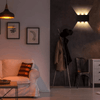 Modern LED Wall Light illuminating a stylish living room with artwork and seating.