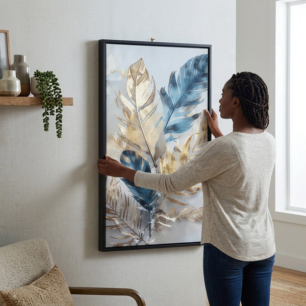A person hanging the Elegant Feathers and Palm Fronds Abstract Art Piece on a wall, showcasing its elegant design.
