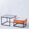 Elegant Coffee Table Set showcasing a modern nesting design with glass and orange accent pieces.