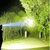 Light beam from USB Rechargeable Waterproof LED Headlamp illuminating a path in a dark forest.