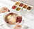 6-Compartment Snack Box with Lid holding ingredients over a pot for meal prep and food organization.