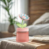 Flower Design Mini USB Air Humidifier & Aroma Diffuser on a bedside table in a cozy bedroom.