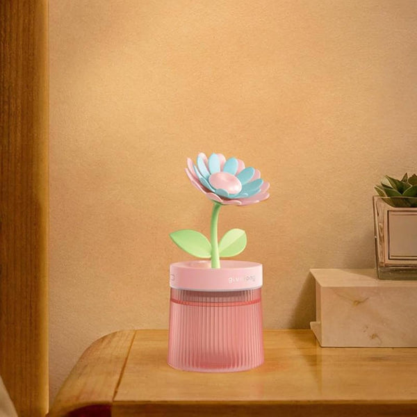 Flower Design Mini USB Air Humidifier & Aroma Diffuser on a bedside table with a warm background.