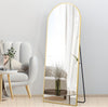 Arched Full Length Floor Mirror with Gold Frame leaning against wall in modern living room decor.