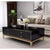Four Drawer Coffee Table with a sleek black finish and gold accents, placed in a modern living room setting.