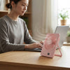 Woman using a Portable Rechargeable Desktop USB Fan while working on a laptop at a desk.