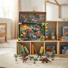 Dinosaur Adventure Playset Box displayed with dinosaur figures and terrain accessories in a playroom setting.