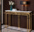 Luxury Faux Marble Gold Base Console Table displayed with decorative items in a stylish hallway setting.
