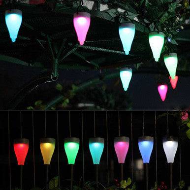 Colorful Sun Glow 6 Pack Solar Garden Light Set illuminating outdoor spaces at night.